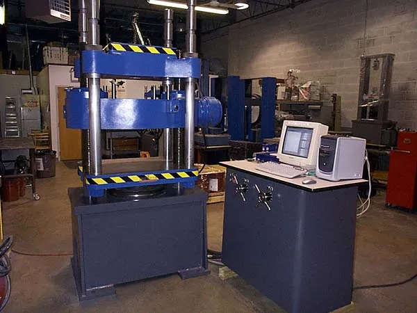 A 400,000 lb capacity manually operated Tinius Olsen Testing Machine retrofitted with ADMET’s MTESTQuattro® Materials Testing System. MTESTQuattro features load, position, axial strain, transverse strain and auxillary input channels