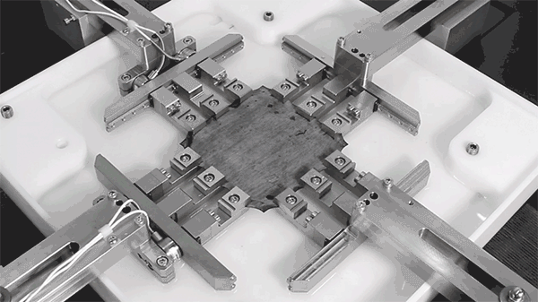 Closeup of test fixtures gripping a square sample