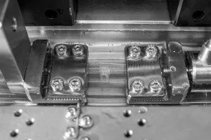 Image of two grips holding a medical adhesive sample performing shear testing