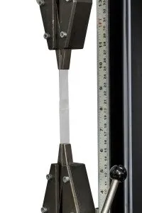 Two grips holding a sample performing a tensile test